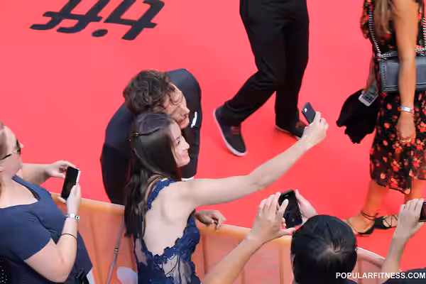 Girl wearing beautiful blue dress posing for a selfie with Sam Claflin at 2016 Toronto International Film Festival for the film Their Finest - #TIFF16.