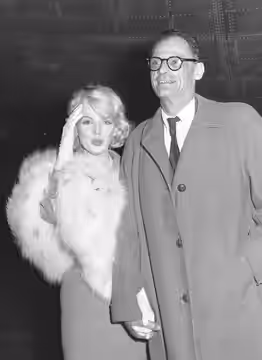 Actress Marilyn Monroe is accompanied by her husband, playwright Arthur Miller, as she arrives at International Airport from New York to start work on a 20th Ce (1959)