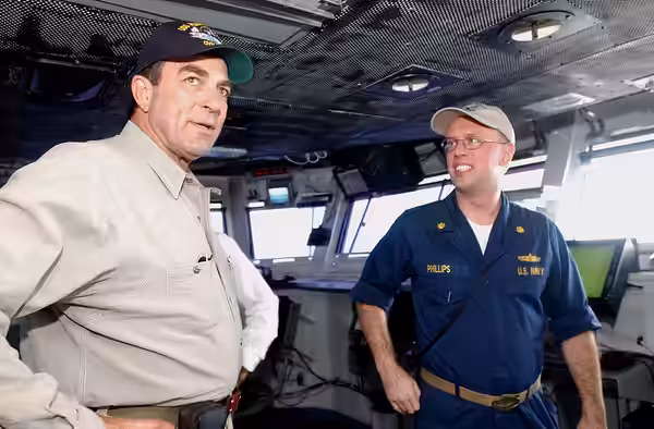 040722-N-5621B-410 Pacific Ocean (July 22, 2004) - Actor Tom Selleck speaks with USS Ronald Reagan (CVN 76) Auxiliary Officer, Lt. Cmdr Clifton Phillips, of Por