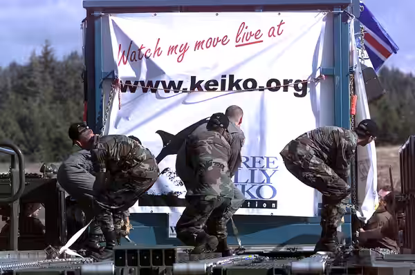 Air Force cargo handlers and loadmasters load the specially made transport tank containing Keiko, the killer whale star of the "Free Willy" movie, onto an Air F