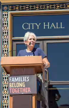 Musician and activist Joan Baez speaks on the steps of San Francisco City Hall for a "Families Belong Together" rally.