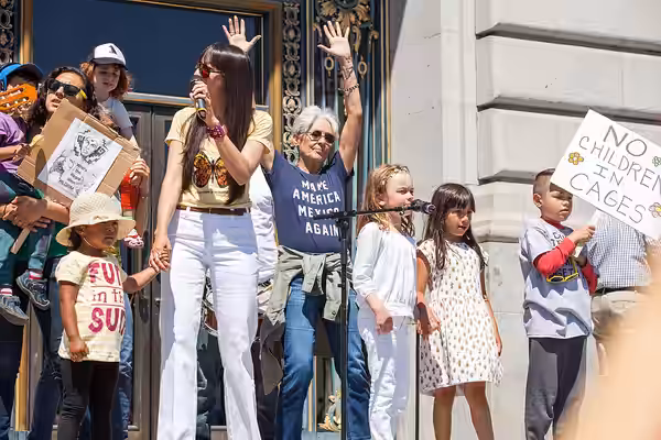 Musicians Diana Gameros and Joan Baez perform with children on the steps of San Francisco City Hall for a "Families Belong Together" rally. Joan Baez wears a sh (2018)