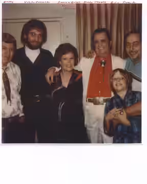 Informal photo of Nelda Fairchild with guitar legend Merle Travis and unidentified friends. Photo reproduced with Fairchild's permission.