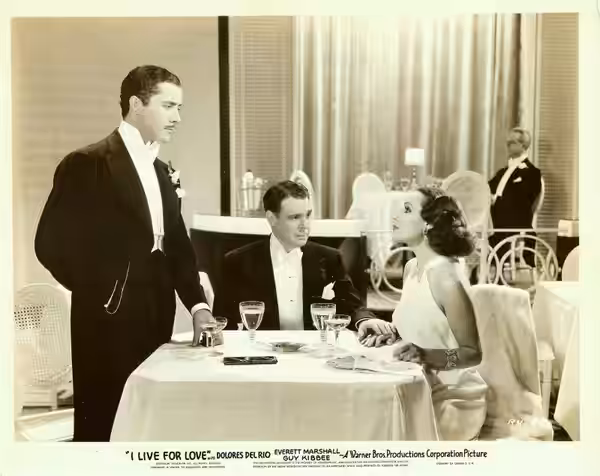 Promotion photo: Dolores del Rio with Don Alvarado and Everett Marshall (sitting) I Live for Love, 1935. Dolores del Rio wears an Orry-Kelly gown.