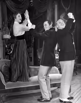 Photo of Julie Andrews, Rex Harrison and Robert Coote from My Fair Lady. In this scene, Eliza's lessons have finally paid off; Eliza, Higgins and Colonel Picker (1957)
