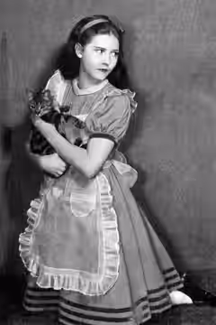 Photograph of Josephine Hutchinson as Alice in the Civic Repertory Company production of Alice in Wonderland (1932) Caption reads as follows: Miss Josephine Hut (1931)