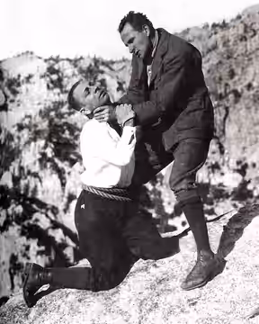 Still from the American drama film Blind Husbands (1919). Universal Pictures. Erich von Stroheim, director. From left to right, Erich von Stroheim and Sam De Gr