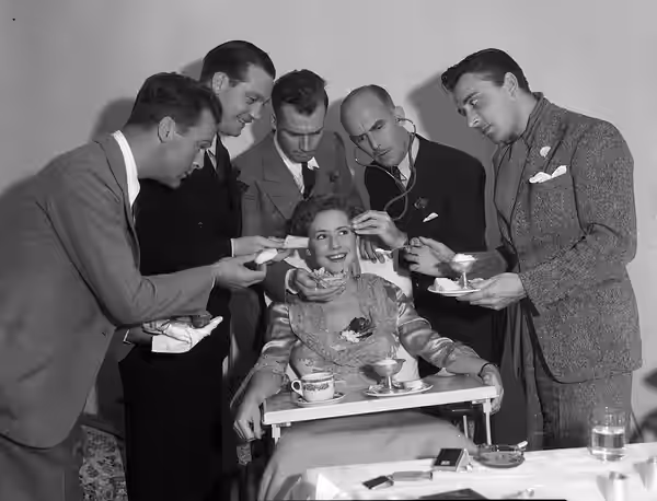 Five male actors (L to R standing: Neil Hamilton, Walter Byron, Russell Gleason, Jimmy [James] Gleason, Leon Waycoff [Leon Ames]) posing with Mae Clarke (1928)