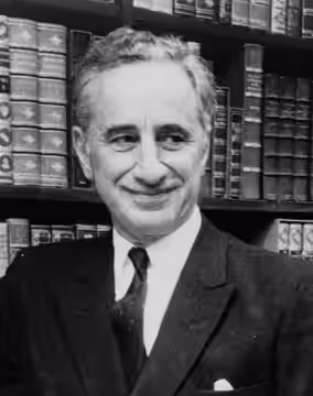 Elia Kazan, full-length portrait, standing before bookshelves at Brentano's book store / World Journal Tribune photo by James Kavallines. (1967)