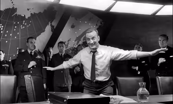 General Buck Turgidson (George C. Scott) demonstrating a B-52 flying low enough to fry chickens in a barnyard. (1964)