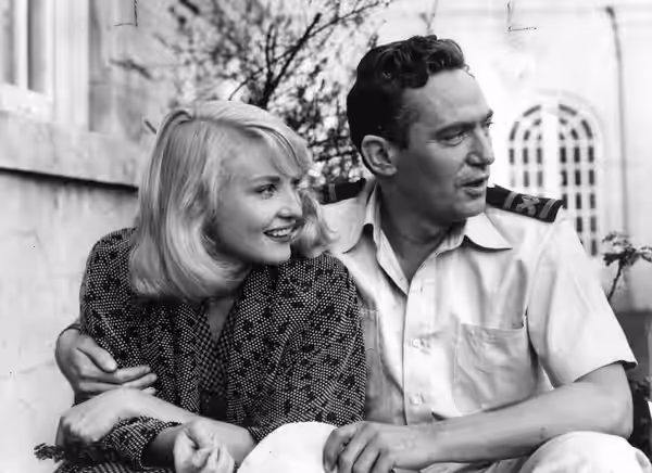 Diane Cilento with Peter Finch. Photographed in London during the making of the film 'Passage Home' (released in 1955). (1954)