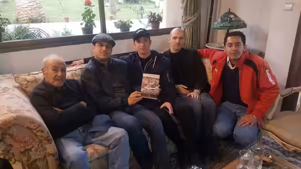 a photograph of Algerian historical and cinematic figure Saadi Yacef with members of Algiers band following their visit to him in March 2019 in Algiers.