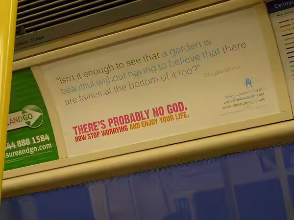 Poster for the Atheist Bus Campaign in a train in the London Underground. The poster prominently displays a quote by Douglas Adams. (2009)