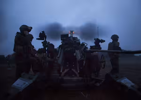 Marines fire an M777A2 lightweight 155 mm howitzer at dusk June 10, 2014 during Artillery Relocation Training Program 14-1 at the Ojojihara Maneuver Area, Japan