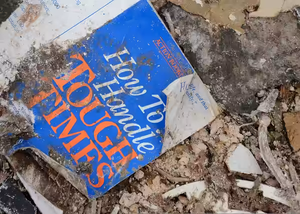 A booklet (How to Handle Tough Times by Norman Vincent Peale) lies amid debris in Moore, Okla., May 26, 2013, six days after an EF5 tornado with winds exceeding