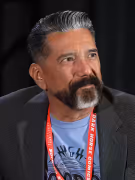 Steven Michael Quezada speaking at the 2024 Rose City Comic Con in Portland, Oregon.
