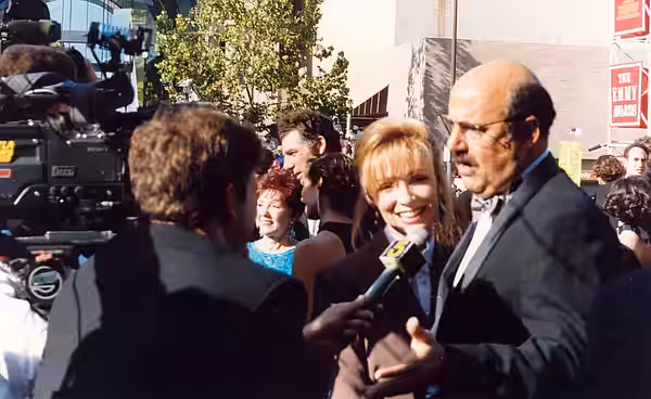 Jeffrey Tambor is interviewed (as is Michael Richards in the background) on the red carpet at the Emmy Awards 1993