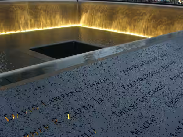 The names of husband and wife 9/11 victims David Angell and Mary Lynn Edwards Angell inscribed in bronze, along with others on panel N-1 of the North Pool of th (2011)
