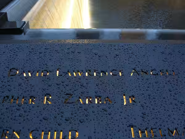 The name of 9/11 victim David Angell inscribed in bronze, along with others on panel N-1 of the North Pool of the National September 11 Memorial &amp; Museum in (2011)