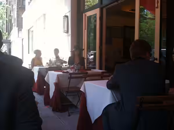 Actress Eliza Dushku (center, wearing the hat) sits at a table at 10 Downing, a restaurant in Manhattan's West Village, during the June 7, 2011 filming of "On t
