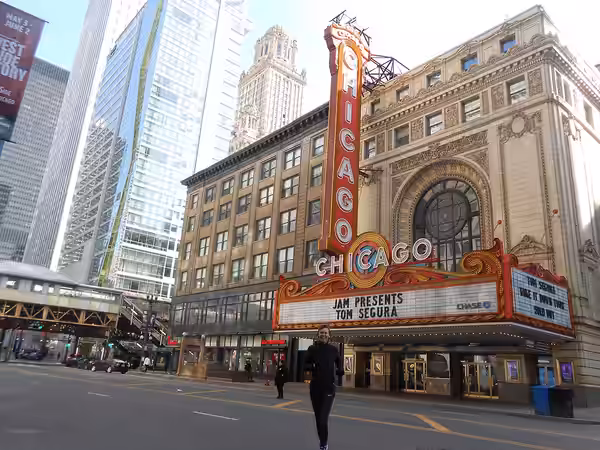 Running across State St. with Chicago's most famous marquee sign in the back ground. (2019)