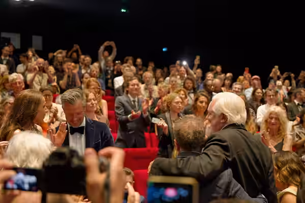 Julian Assange and Eugene Jarecki in the audience after the premiere of The Six Billion Dollar Man at the 2025 Cannes Film Festival