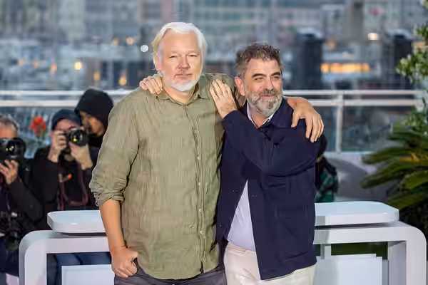 Julian Assange and Eugene Jarecki at 2025 Cannes The Six Billion Dollar Man Photocall