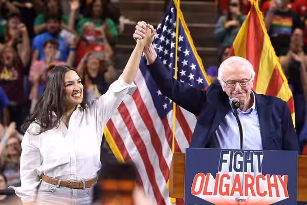 U.S. Congresswoman Alexandria Ocasio-Cortez and U.S. Senator Bernie Sanders speaking with attendees at a "Fight Oligarchy" rally at Mullett Arena in Tempe, Ariz (2025)