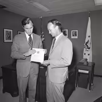 Ambassador George H. W. Bush Presents a Bible to Michael Collins (1971)