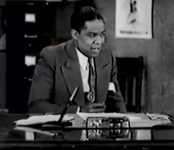 James Baskett (credited as "Jimmy Baskette") performing as the character "Money" Johnson in the film Harlem Is Heaven (1932) - cropped screenshot