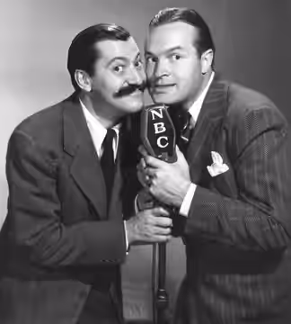 Promotional photo of Jerry Colonna and Bob Hope from Hope's radio program. This photo was produced prior to 1978 and has no copyright markings. It can be dated 