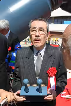 矢田稔。日本・東京出身の声優。2009年10月4日、兵庫県神戸市長田区若松公園にて開催された鉄人28号増完成記念式典にて撮影。