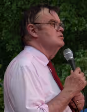 Garrison Keillor during a rainy outdoor broadcast of A Prairie Home Companion. (2007)