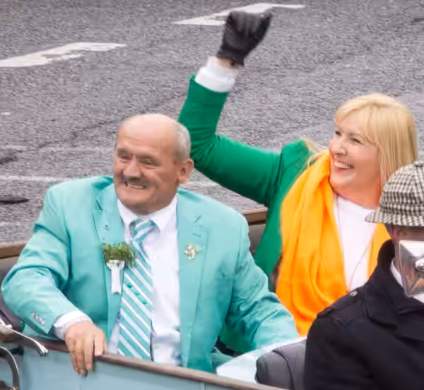 Brendan O'Carroll (left) and Jennifer Gibney (right) being driven in a vintage car in the 2015 Dublin St Patrick's Day Parade