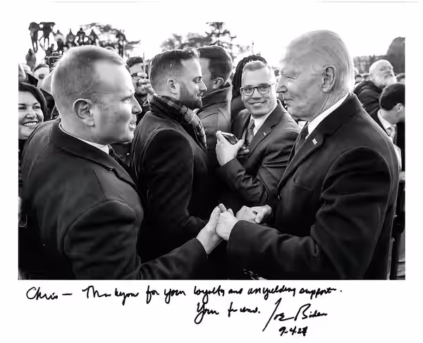 Chris D. Jackson shaking hands with President Joe Biden. This official White House photograph is signed by President Biden with a personal message. (2022)