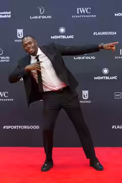 Capturing the essence of victory, Usain Bolt strikes his iconic pose on the red carpet at the 25th Laureus World Sports Awards. (2024)