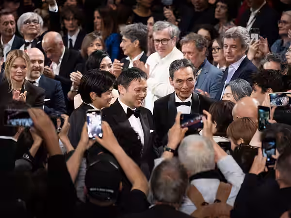 MAY 16, 2026 - Japanese director Ryusuke Hamaguchi and Japanese actors Kyōzō Nagatsuka and Kodai Kurosaki pose during the standing ovation for their film All Of