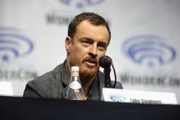 Toby Stephens speaking at the 2018 WonderCon, for "Netflix's Lost in Space", at the Anaheim Convention Center in Anaheim, California. Please attribute to Gage S