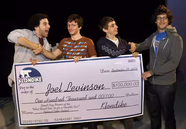 Joel Moss Levinson receives a giant promotional check from the members of the Lonely Island during a trip won to New York as part of a contest hosted by Klondik (2008)