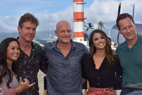 Lifestyle reporter Jobeth Devera and Extra TV correspondent Jennifer Lahmers strike a pose with Midway cast members Dennis Quaid, Woody Harrelson, and Patrick W