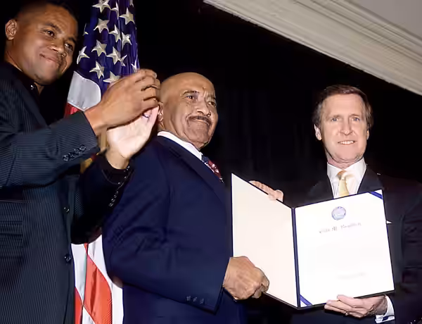 Master Chief Petty Officer Carl Brashear (center), the Navy's first African-American diver, received an Outstanding Public Service Award in October 2000 from ac