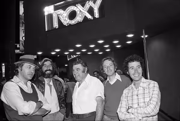 From left, Bill Graham, Lou Adler, Chuck Landis, Elliot Roberts and David Geffen standing under the Roxy nightclub marquee in Los Angeles (1973)