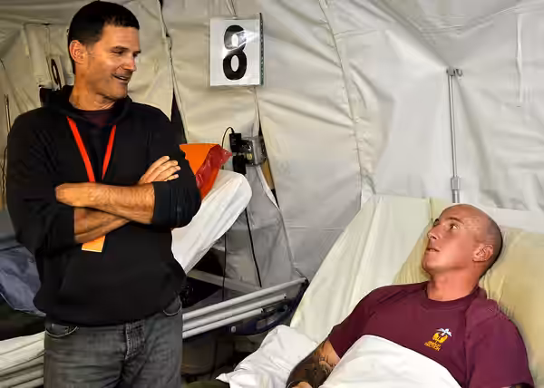 KANDAHAR AIRFIELD, Afghanistan - Celebrity D.W. Moffett visits with a wounded British troop Oct. 13 at the Role III coalition hospital here. Moffett, along with (2009)