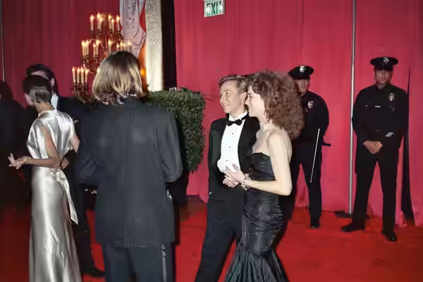 Keith Coogan and his date talk with River Phoenix (back to camera). Phoenix's date Martha Plimpton can be seen in shiny white dress at left. Photo taken at the  (1989)