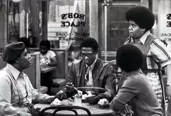 Partial cast photo from the television program What's Happening. Seated, from left Fred Berry (Rerun), Ernest Lee Thomas (Raj), Haywood Nelson (back to camera - (1977)
