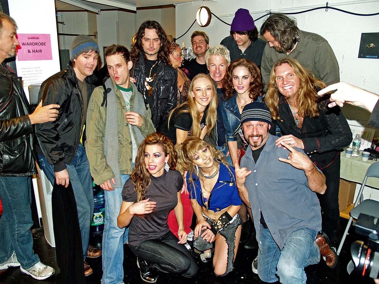 Constantine Maroulis, Kelli Barrett and the 2008 cast of off-Broadway musical Rock of Ages pose backstage with Kevin Cronin.