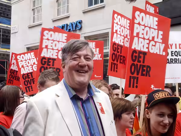 Stephen Fry with Caitlin McQue of Nottingham and other Stonewall marchers at London's WorldPride on 7 July 2012.