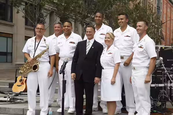 120824-N-HG258-113 WASHINGTON, D.C. (August 24, 2012) The Cruisers pose with actor Gary Sinise after a ceremony designating Sinise an Honorary Chief Petty Offic