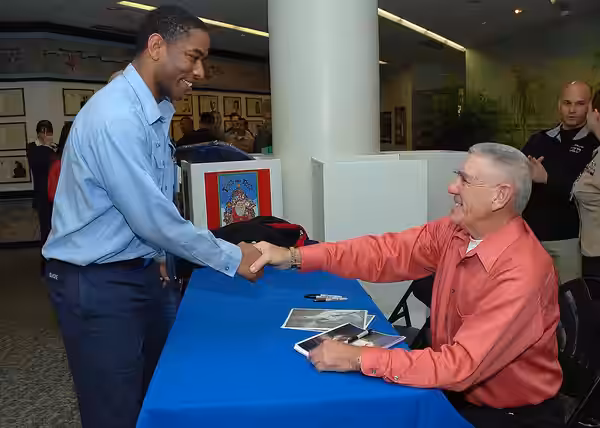 Former U.S. Marine Corps drill instructor turned Golden Globe-nominated actor R. Lee Ermey signs an autograph for Petty Officer 2nd Class Maurice Elmore during  (2008)