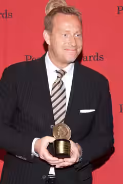 Adam Price with a Peabody Award for the television show "Borgen" (2014)
